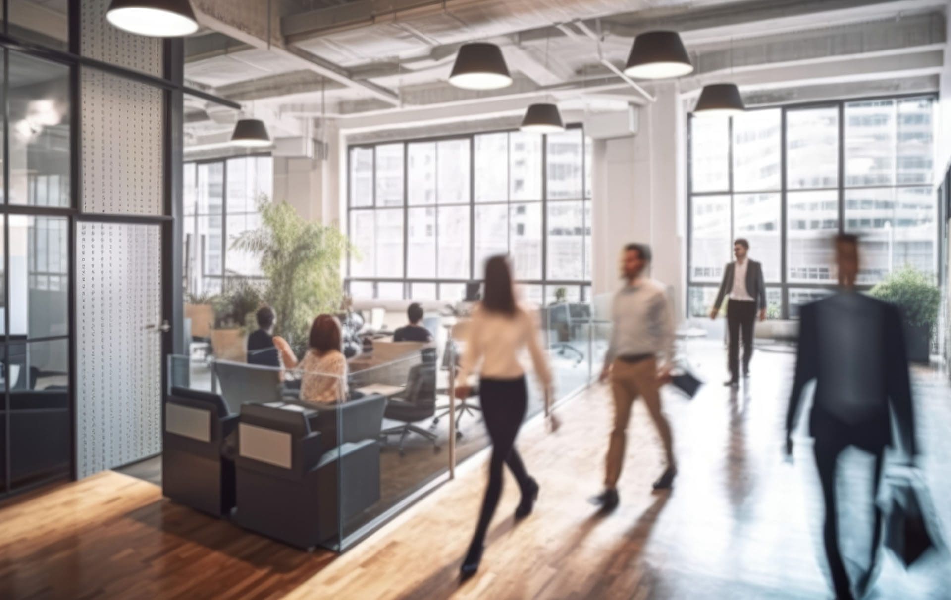 Modern office interior with busy business people walking around.